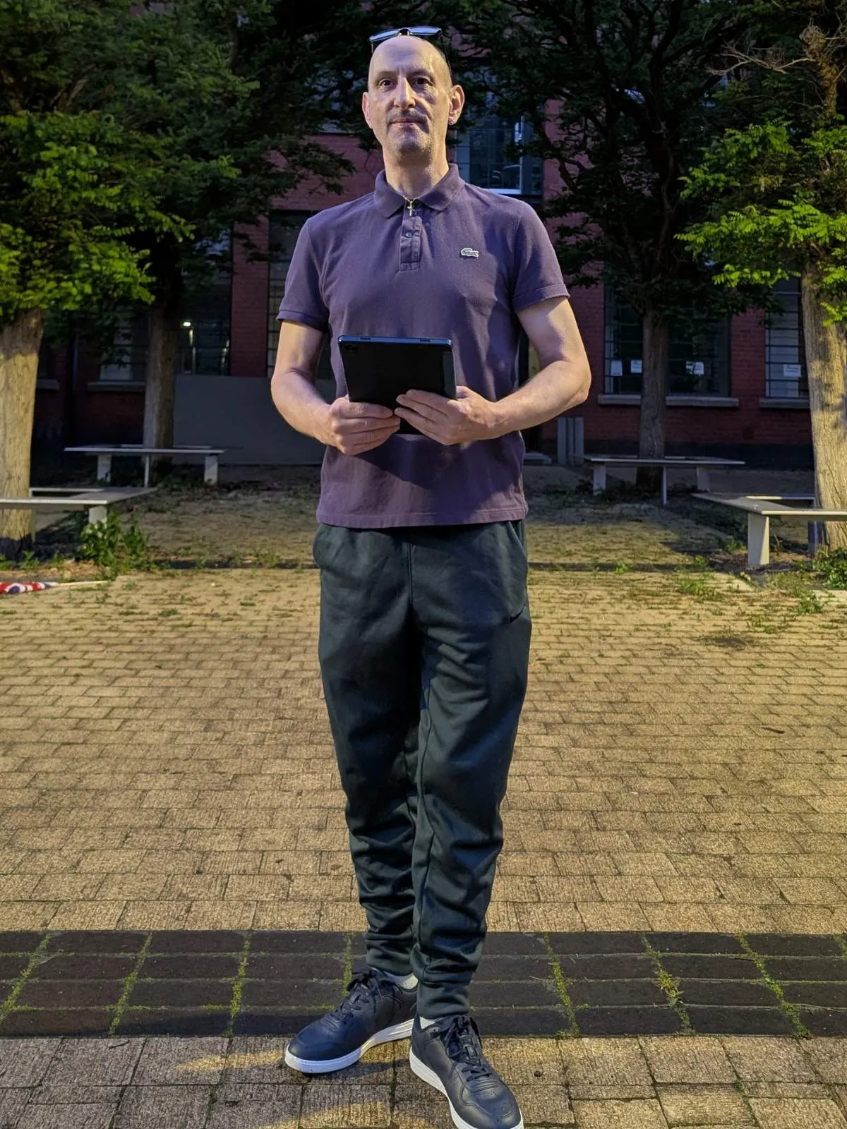 Trafford Digital Creator supporting local businesses in Trafford standing outside the beautiful Trafford Park Village.